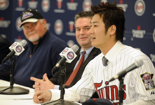 MINNEAPOLIS, MN - DECEMBER 18: Tsuyoshi Nishioka #1 of the Minnesota Twins speaks to members of the media as manager Ron Gardenhire (L) and general manager Bill Smith (C) look on during a press conference December 18, 2010 at Target Field in Minneapolis, Minnesota. (Photo by Hannah Foslien/Getty Images)