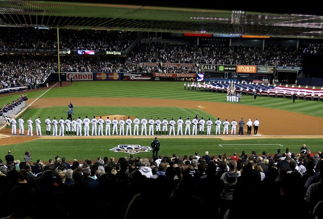 NEW YORK - OCTOBER 09:  The New York Yankees and the Minnesota Twins stand for the performance of the National Anthem during Game Three of the ALDS part of the 2010 MLB Playoffs at Yankee Stadium on October 9, 2010 in the Bronx borough of New York City.  (Photo by Chris McGrath/Getty Images)