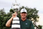 DURBAN, SOUTH AFRICA - DECEMBER 19:  Ernie Els of South Africa celebrates with the trophy after round four of the South African Open Golf Championship at the Durban Country Club on December 19, 2010 in Durban, South Africa.  (Photo by Julian Finney/Getty Images)