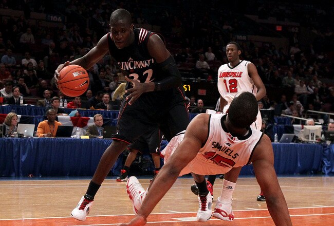 NEW YORK - MARCH 10: Samardo Samuels #15 of the Louisville Cardinals falls to the court against Ibrahima Thomas #32 of the Cincinnati Bearcats during the second round of 2010 NCAA Big East Tournament at Madison Square Garden on March 10, 2010 in New York City.  (Photo by Jim McIsaac/Getty Images)