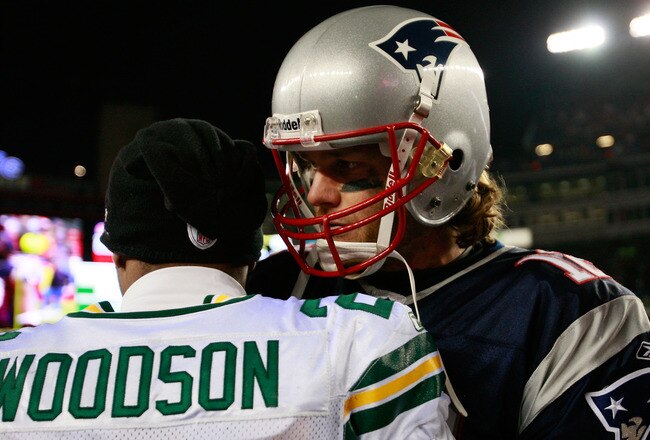 FOXBORO, MA - DECEMBER 19:  Quarterback Tom Brady #12 of the New England Patriots is congratulated by cornerback Charles Woodson #21 of the Green Bay Packers at Gillette Stadium on December 19, 2010 in Foxboro, Massachusetts. The Patriots won the game 31-27.  (Photo by Jim Rogash/Getty Images)