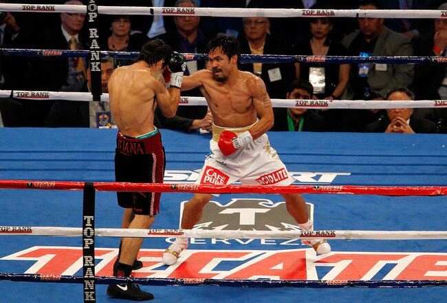 ARLINGTON, TX - NOVEMBER 13:  Manny Pacquiao (white trunks) of the Philippines fights against Antonio Margarito (black trunks) of Mexico during their WBC World Super Welterweight Title bout at Cowboys Stadium on November 13, 2010 in Arlington, Texas.  (Photo by Tom Pennington/Getty Images)