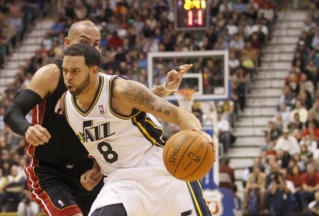 SALT LAKE CITY, UT - DECEMBER 8:  Deron Williams #8 of the Utah Jazz drives on Carlos Arroyo #8 the Miami Heat during the second half of an NBA game December 8, 2010 at Energy Solutions Arena in Salt Lake City, Utah. The Heat beat the Jazz 111-98. NOTE TO USER:  User expressly acknowledges and agrees that, by downloading and or using this photograph, User is consenting to the terms and conditions of the Getty Images License Agreement.  (Photo by George Frey/Getty Images)