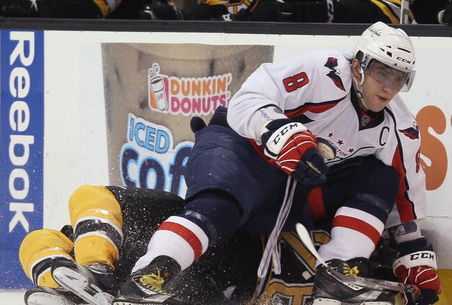 BOSTON, MA - DECEMBER 18:  Alex Ovechkin #8 of the Washington Capitals topples Blake Wheeler #26 of the Boston Bruins on December 18, 2010 at the TD Garden in Boston, Massachusetts. The Bruins defeated the Capitals 3-2.  (Photo by Elsa/Getty Images)