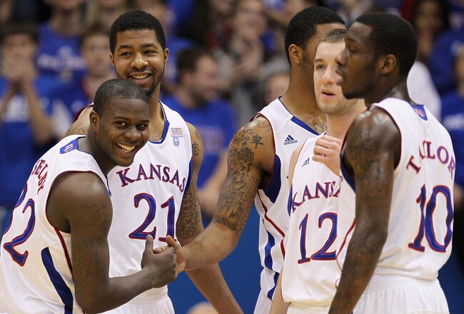 LAWRENCE, KS - DECEMBER 18:  Josh Selby #32 of the Kansas Jayhawks jokes with teammates prior to the start of the game against the USC Trojans on December 18, 2010 at Allen Fieldhouse in Lawrence, Kansas.  (Photo by Jamie Squire/Getty Images)
