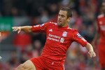 LIVERPOOL, ENGLAND - OCTOBER 03:  Joe Cole of Liverpool tackles Keith Southern of Blackpool during the Barclays Premier League match between Liverpool and Blackpool at Anfield on October 3, 2010 in Liverpool, England.  (Photo by Alex Livesey/Getty Images)