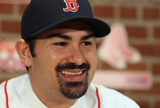 BOSTON, MA - DECEMBER 06:  Adrian Gonzalez answers questions during a press conference to announce his signing with the Boston Red Sox on December 6,  2010 at Fenway Park in Boston, Massachusetts.  (Photo by Elsa/Getty Images)