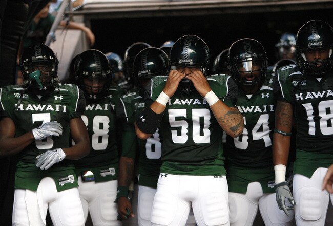 HONOLULU - SEPTEMBER 02: Mana Lolotai #50 of the University of Hawaii Warriors checks his helmet before the Warriors take the field in their season opener against the University of Southern California Trojans at Aloha Stadium September 2, 2010 in Honolulu, Hawaii. (Photo by Kent Nishimura/Getty Images)