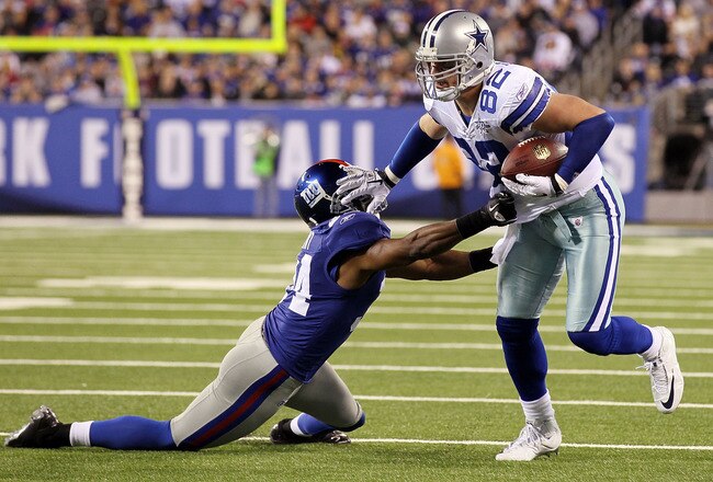 EAST RUTHERFORD, NJ - NOVEMBER 14:  Jason Witten #82 of the Dallas Cowboys stiff arms Deon Grant #34 of the New York Giants as he runs the ball on November 14, 2010 at the New Meadowlands Stadium in East Rutherford, New Jersey.  (Photo by Jim McIsaac/Getty Images)