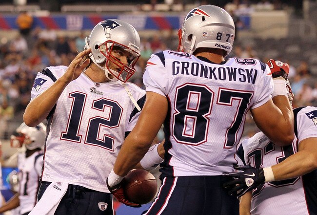 EAST RUTHERFORD, NJ - SEPTEMBER 02:  Tom Brady #12 and Rob Gronkowski #87 of the New England Patriots celebrate after teaming up for a first quarter touchdown against the New York Giants on September 2, 2010 at the New Meadowlands Stadium in East Rutherford, New Jersey.  (Photo by Jim McIsaac/Getty Images)