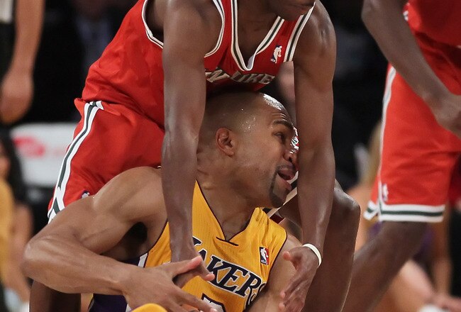 LOS ANGELES, CA - DECEMBER 21:  Earl Boykins #11 of the Milwaukee Bucks ties up Derek Fisher #2 of the Los Angeles Lakers during the second half at Staples Center on December 21, 2010 in Los Angeles, California. The Bucks defeated the Lakers 98-79. NOTE TO USER: User expressly acknowledges and agrees that, by downloading and or using this photograph, User is consenting to the terms and conditions of the Getty Images License Agreement.  (Photo by Jeff Gross/Getty Images)