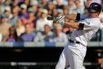 DENVER - APRIL 09:  Brad Hawpe #11 of the Colorado Rockies singles in the eighth inning off of Sean Gallagher of the San Diego Padres during MLB action on Opening Day at Coors Field on April 9, 2010 in Denver, Colorado. The Rockies defeated the Padres 7-0.  (Photo by Doug Pensinger/Getty Images)