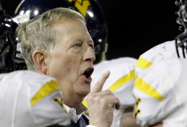 CINCINNATI - NOVEMBER 13:  Head coach Bill Stewart of the West Virginia Mountaineers meets with his team in the fourth quarter of the game against the Cincinnati Bearcats at Nippert Stadium on November 13, 2009 in Cincinnati, Ohio.  (Photo by Andy Lyons/Getty Images)