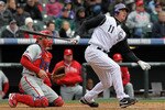 DENVER - MAY 12:  Brad Hawpe #11 of the Colorado Rockies follows through on his two RBI triple to tie the score 3-3 against the Philadelphia Phillies in the seventh inning at Coors Field on May 12, 2010 in Denver, Colorado. The Rockies defeated the Phillies 4-3 in 10 innings.  (Photo by Doug Pensinger/Getty Images)
