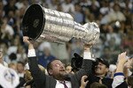 TAMPA, FL - JUNE 7:  Executive Vice President and General Manager Jay Feaster of the Tampa Bay Lightning holds the Stanley Cup above his head after the victory over the Calgary Flames in Game seven of the NHL Stanley Cup Finals on June 7, 2004 at the St. Pete Times Forum in Tampa, Florida.  The Lightning defeated the Flames 2-1.  (Photo by Brian Bahr/Getty Images)