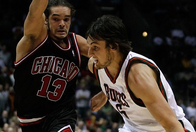 MILWAUKEE - NOVEMBER 30: Andrew Bogut #6 of the Milwuakee Bucks drives around Joakim Noah #13 of the Chicago Bulls at the Bradley Center on November 30, 2009 in Milwaukee, Wisconsin. The Bucks defeated the Bulls 99-97. NOTE TO USER: User expressly acknowledges and agrees that, by downloading and/or using this Photograph, User is consenting to the terms and conditions of the Getty Images License Agreement. (Photo by Jonathan Daniel/Getty Images)