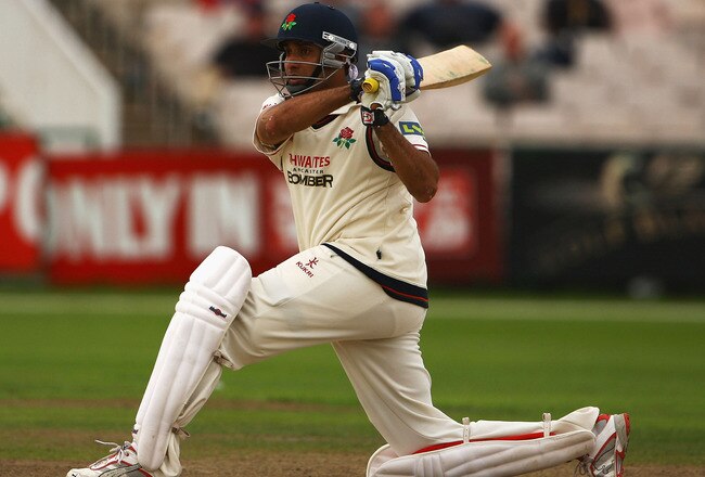MANCHESTER, ENGLAND - AUGUST 12:  VVS Laxman of Lancashire hits the ball towards the boundary during the LV County Championship Division One match between Lancashire and Durham at Old Trafford on August 12, 2009 in Manchester, England.  (Photo by Matthew Lewis/Getty Images)