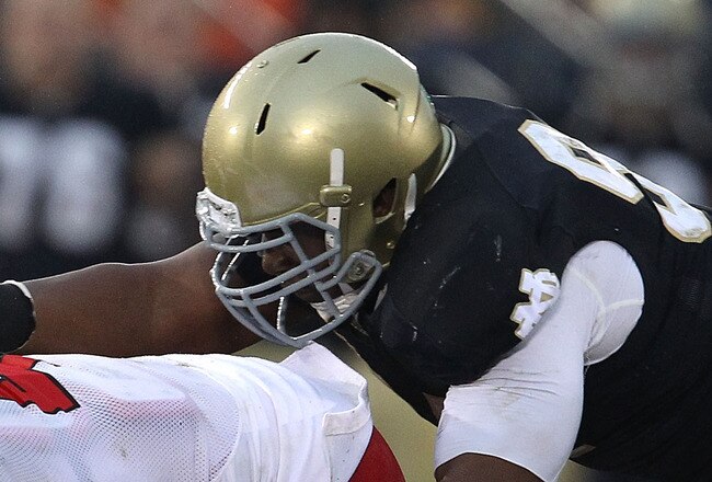SOUTH BEND, IN - NOVEMBER 13: Manti Te'o #5 and Emeka Nwankwo #91 of the Notre Dame Fighting Irish tackle Matt Asiata #4 of the Utah Utes at Notre Dame Stadium on November 13, 2010 in South Bend, Indiana. Notre Dame defeated Utah 28-3. (Photo by Jonathan Daniel/Getty Images)
