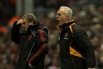 LIVERPOOL, ENGLAND - DECEMBER 29:  Wolverhampton Wanderers Manager Mick McCarthy issues instructions as Liverpool Manager Roy Hodgson looks on during the Barclays Premier League match between Liverpool and Wolverhampton Wanderers at Anfield on December 29, 2010 in Liverpool, England.  (Photo by Clive Brunskill/Getty Images)
