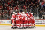 DENVER - DECEMBER 27:  The Detroit Red Wings mob their goalie Chris Osgood #30 of the Detroit Red Wings after he earned his 400th win with a victory over the Colorado Avalanche at the Pepsi Center on December 27, 2010 in Denver, Colorado. Osgood collected 46 saves as the Red Wings defeated the Avalanche 4-3 in overtime.  (Photo by Doug Pensinger/Getty Images)