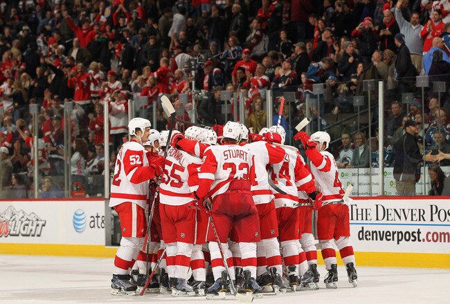 DENVER - DECEMBER 27:  The Detroit Red Wings mob their goalie Chris Osgood #30 of the Detroit Red Wings after he earned his 400th win with a victory over the Colorado Avalanche at the Pepsi Center on December 27, 2010 in Denver, Colorado. Osgood collected 46 saves as the Red Wings defeated the Avalanche 4-3 in overtime.  (Photo by Doug Pensinger/Getty Images)