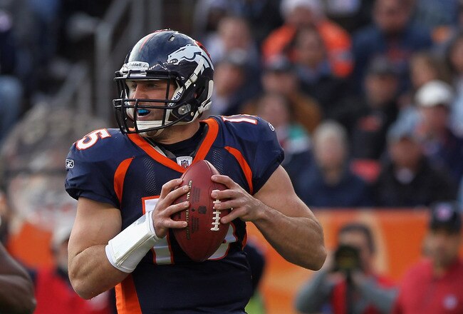 DENVER - DECEMBER 26:  Quarterback Tim Tebow #15 of the Denver Broncos rolls out and looks to deliver a pass against the Houston Texas at INVESCO Field at Mile High on December 26, 2010 in Denver, Colorado. The Broncos defeated the Texans 24-23.  (Photo by Doug Pensinger/Getty Images)