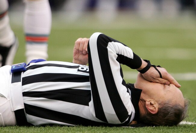 BALTIMORE - JANUARY 2:  Referee Bernie Kukar tries to collect himself after colliding with a member of the Miami Dolphins as the Baltimore Ravens defeated the Dolphins 30-23 during NFL action at M&T Bank Stadium on January 2, 2005 in Baltimore, Maryland.  (Photo by Doug Pensinger/Getty Images)