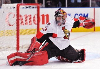 NEW YORK, NY - DECEMBER 5: Pascal Leclaire #33 of the Ottawa Senators deflects a shot on goal during the second period against the New York Rangers at Madison Square Garden on December 5, 2010 in New York City. (Photo by Christopher Pasatieri/Getty Images)