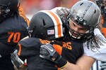 CORVALLIS, OR - DECEMBER 4: Jacquizz Rodgers #1 of the Oregon State Beavers is wrapped up by Casey Matthews #55 and Wade Keliikipi #92 of the Oregon Ducks in the first quarter of the game at Reser Stadium on December 4, 2010 in Corvallis, Oregon. The Ducks beat the Beavers 37-20 to go on the BCS Championship game on January 10, 2011.  (Photo by Steve Dykes/Getty Images)