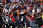 DENVER - DECEMBER 26:  Quarterback Tim Tebow #15 of the Denver Broncos rolls out and looks to deliver a pass against the Houston Texas at INVESCO Field at Mile High on December 26, 2010 in Denver, Colorado. The Broncos defeated the Texans 24-23.  (Photo by Doug Pensinger/Getty Images)