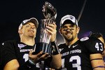 PASADENA, CA - JANUARY 01:  Quarterback Andy Dalton #14 and linebacker Tank Carder #43 of the TCU Horned Frogs hold the Rose Bowl Championship Trophy after defeating the Wisconsin Badgers 21-19 in the 97th Rose Bowl game on January 1, 2011 in Pasadena, California.  (Photo by Jeff Gross/Getty Images)