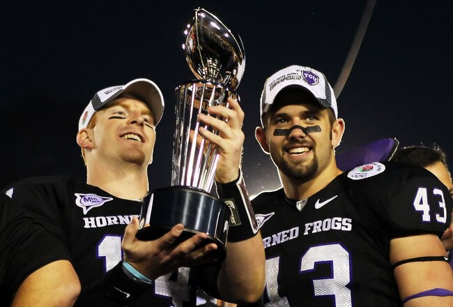 PASADENA, CA - JANUARY 01:  Quarterback Andy Dalton #14 and linebacker Tank Carder #43 of the TCU Horned Frogs hold the Rose Bowl Championship Trophy after defeating the Wisconsin Badgers 21-19 in the 97th Rose Bowl game on January 1, 2011 in Pasadena, California.  (Photo by Jeff Gross/Getty Images)