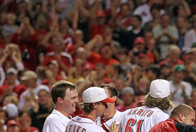 CINCINNATI - SEPTEMBER 11:  Joey Votto #19 of the Cincinnati Reds is mobbed by his teammates after hitting a game winning home run during the game against the Pittsburg Pirates at Great American Ball Park on September 11, 2010 in Cincinnati, Ohio. The Reds won 5-4  (Photo by Andy Lyons/Getty Images)