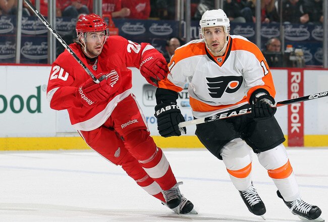 DETROIT, MI - JANUARY 2:  Blair Betts #11 of the Philadelphia Flyers runs into the check of Drew Miller #20 of the Detroit Red Wings in a game on January 2, 2011 at the Joe Louis Arena in Detroit, Michigan. (Photo by Claus Andersen/Getty Images)