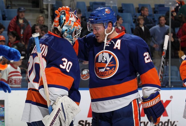 UNIONDALE, NY - OCTOBER 16:  James Wisniewski #20 and Dwayne Roloson #30 of the New York Islanders celebrate against the Colorado Avalanche on October 16, 2010 at Nassau Coliseum in Uniondale, New York.  (Photo by Jim McIsaac/Getty Images)
