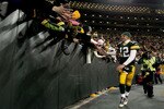 GREEN BAY, WI - JANUARY 02:  Quarterback Aaron Rodgers #12 of the Green Bay Packers circles the field after the Packers win over the Chicago Bears at Lambeau Field on January 2, 2011 in Green Bay, Wisconsin.  (Photo by Matthew Stockman/Getty Images)