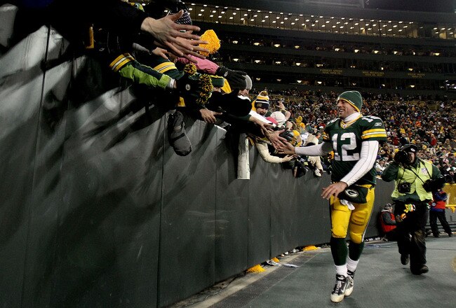 GREEN BAY, WI - JANUARY 02:  Quarterback Aaron Rodgers #12 of the Green Bay Packers circles the field after the Packers win over the Chicago Bears at Lambeau Field on January 2, 2011 in Green Bay, Wisconsin.  (Photo by Matthew Stockman/Getty Images)