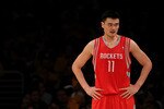 LOS ANGELES, CA - OCTOBER 26:  Yao Ming #11 of the Houston Rockets looks on during their opening night game against the Los Angeles Lakers at Staples Center on October 26, 2010 in Los Angeles, California. NOTE TO USER: User expressly acknowledges and agrees that, by downloading and or using this photograph, User is consenting to the terms and conditions of the Getty Images License Agreement.  (Photo by Jeff Gross/Getty Images)