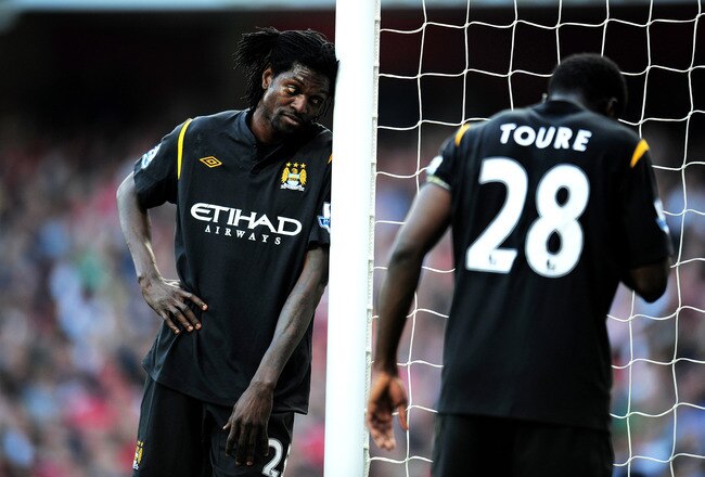 LONDON, ENGLAND - APRIL 24:  Emmanuel Adebayor (L) of Manchester City and teammate Kolo Toure look on during the Barclays Premier League match between Arsenal and Manchester City at the Emirates Stadium on April 24, 2010 in London, England.  (Photo by Shaun Botterill/Getty Images)