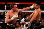 NEW YORK - MAY 15:   Paulie Malignaggi (L) hits Amir Khan of Great Britain during the WBA light welterweight title fight at Madison Square Garden on May 15, 2010 in New York City.  (Photo by Chris Trotman/Getty Images)