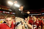 MIAMI, FL - JANUARY 03: Head coach Jim Harbaugh of the Stanford Cardinal celebrates as he is lifted up by his players including Orange Bowl MVP Andrew Luck #12 (R) after Stanford won 40-12 against the Virginia Tech Hokies during the 2011 Discover Orange Bowl at Sun Life Stadium on January 3, 2011 in Miami, Florida. (Photo by Streeter Lecka/Getty Images)
