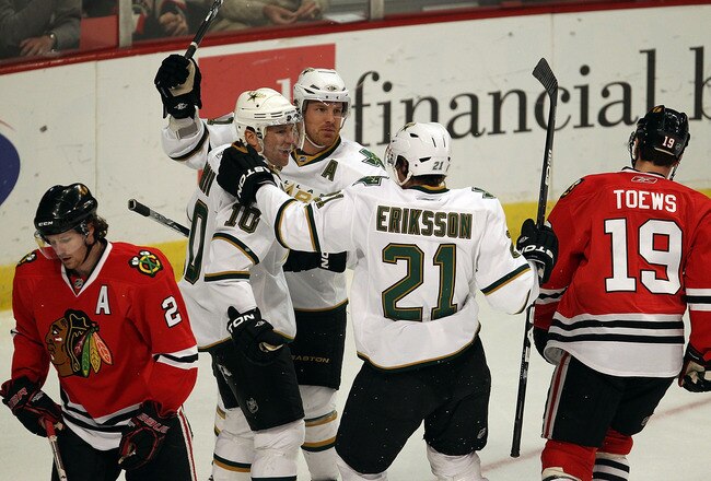 CHICAGO, IL - JANUARY 05: (L-R) Brenden Morrow #10, Brad Richards #91 and Loui Eriksson #21 of the Dallas Stars celebrate Morrows' 1st period goal as Duncan Kieth #2 and Jonathan Toews #19 of the Chicago Blackhawks skate away at the United Center on January 5, 2011 in Chicago, Illinois. (Photo by Jonathan Daniel/Getty Images)