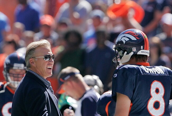 DENVER - SEPTEMBER 19:  Quarterback Kyle Orton #8 of the Denver Broncos shakes hands with former Denver Broncos quarterback John Elway before an NFL game against the Seattle Seahawks at INVESCO Field at Mile High on September 19, 2010 in Denver, Colorado.  (Photo by Justin Edmonds/Getty Images)
