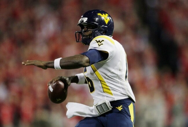 CINCINNATI - NOVEMBER 13: Quarterback Jarrett Brown #16 of the West Virginia Mountaineers throws a touchdown pass in the fourth quarter against the Cincinnati Bearcats at Nippert Stadium on November 13, 2009 in Cincinnati, Ohio. The Bearcats won the game 24-21. (Photo by Andy Lyons/Getty Images)