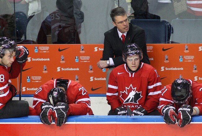 BUFFALO, NY - JANUARY 05: Dave Cameron, head coach  of Team Canada stands with some of his players after losing to Russia during the 2011 IIHF World U20 Championship Gold medal game between Canada and Russia at the HSBC Arena on January 5, 2011 in Buffalo, New York. Russia scored 5 unanswered goals in the third period to win. (Photo by Rick Stewart/Getty Images)