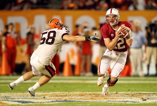 MIAMI, FL - JANUARY 03: Andrew Luck #12 of the Stanford Cardinal ellude Jack Tyler #58 of the Virginia Tech Hokies during the 2011 Discover Orange Bowl at Sun Life Stadium on January 3, 2011 in Miami, Florida. STanford won 40-12. (Photo by Mike Ehrmann/Getty Images)