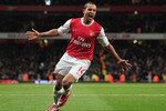 LONDON, ENGLAND - DECEMBER 27:  Theo Walcott of Arsenal celebrates Arsenal's third goal during the Barclays Premier League match between Arsenal and Chelsea at the Emirates Stadium on December 27, 2010 in London, England.  (Photo by Shaun Botterill/Getty Images)