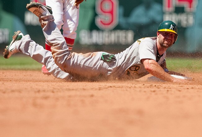 ST. LOUIS - JUNE 20: Kevin Kouzmanoff #5 of the Oakland Athletics slides into second base to avoid a pick off against the St. Louis Cardinals at Busch Stadium on June 20, 2010 in St. Louis, Missouri.  The Athletics beat the Cardinals 3-2.  (Photo by Dilip Vishwanat/Getty Images)