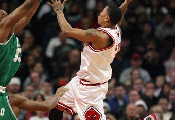 CHICAGO - DECEMBER 12: Derrick Rose #1 of the Chicago Bulls puts up a shot against Shelden Williams #13 of the Boston Celtics at the United Center on December 12, 2009 in Chicago, Illinois. NOTE TO USER: User expressly acknowledges and agrees that, by downloading and/or using this Photograph, User is consenting to the terms and conditions of the Getty Images License Agreement. (Photo by Jonathan Daniel/Getty Images)