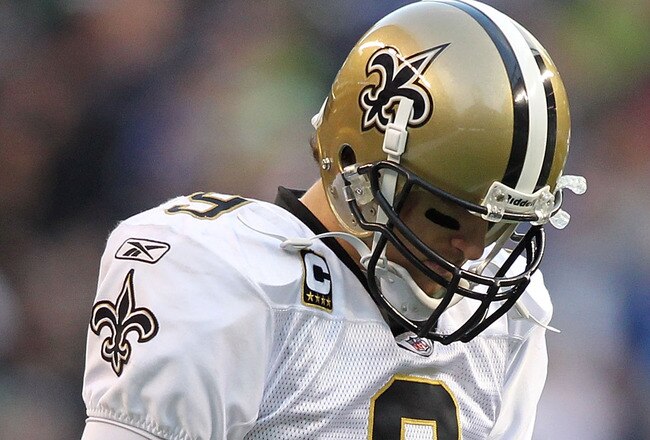 SEATTLE, WA - JANUARY 08:  Quarterback Drew Brees #9 of the New Orleans Saints looks dwon in the second half against the Seattle Seahawks during the 2011 NFC wild-card playoff game at Qwest Field on January 8, 2011 in Seattle, Washington.  (Photo by Jonathan Ferrey/Getty Images)